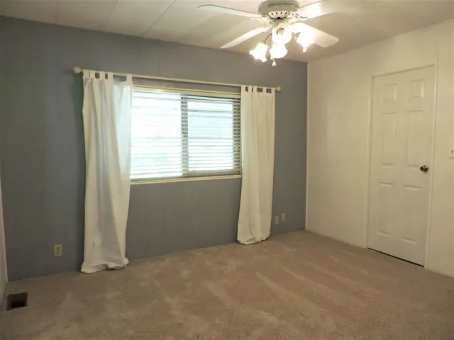 a bathroom with a sink a toilet a mirror and shower curtain