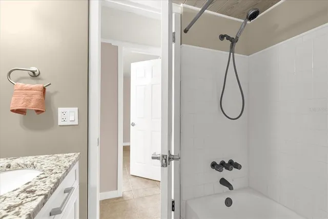 a bathroom with a bath tub and shower