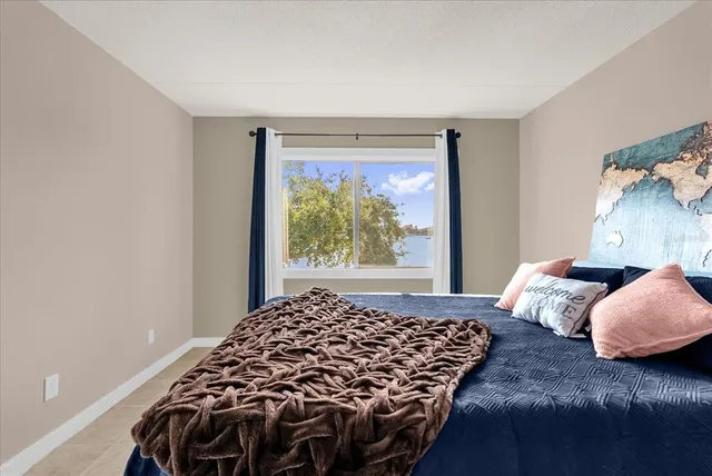 a bedroom with bed and window