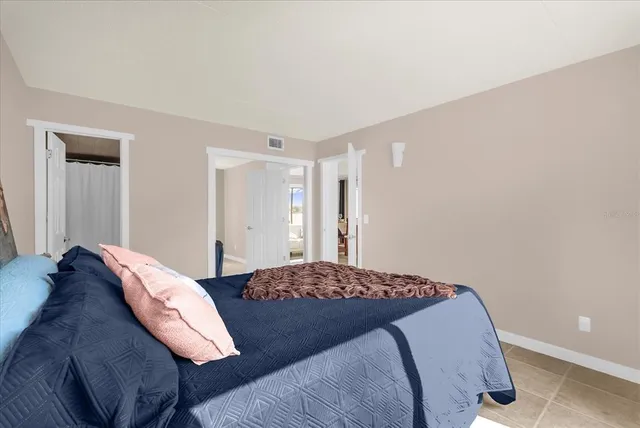 a bedroom with a bed and a lamp with closet