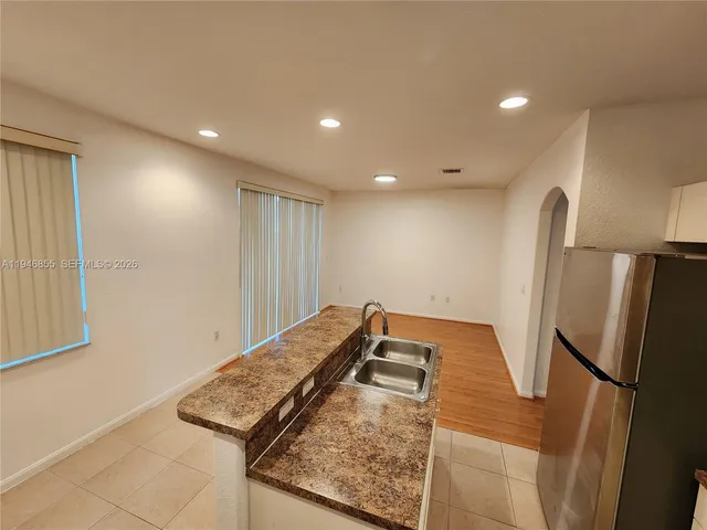a view of a kitchen with a refrigerator