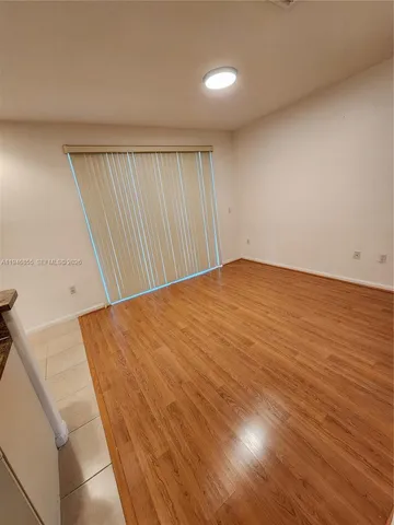 an empty room with wooden floor
