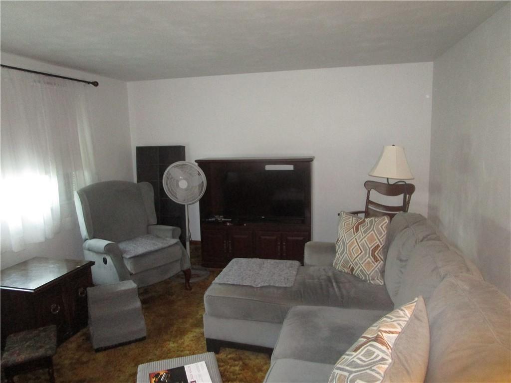 112 State Hill Road Smithton, PA 15479 - Photo 11 of 25 a living room with furniture and a chair