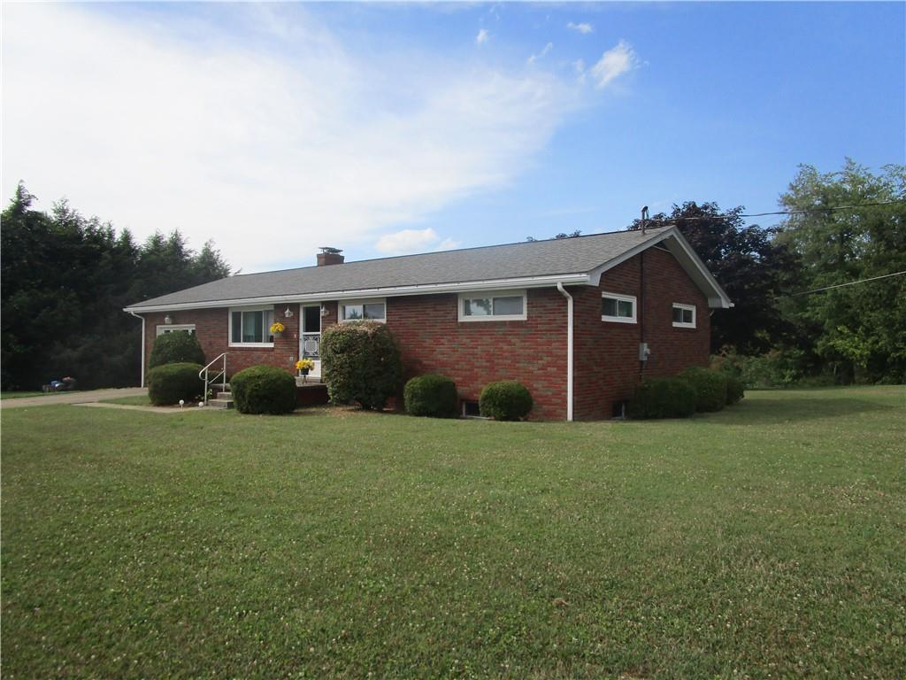 112 State Hill Road Smithton, PA 15479 - Photo 2 of 25 a front view of a house with a garden
