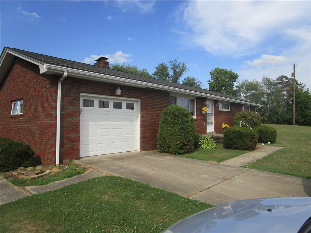 112 State Hill Road Smithton, PA 15479 - Photo 4 of 25 a front view of a house with a garden