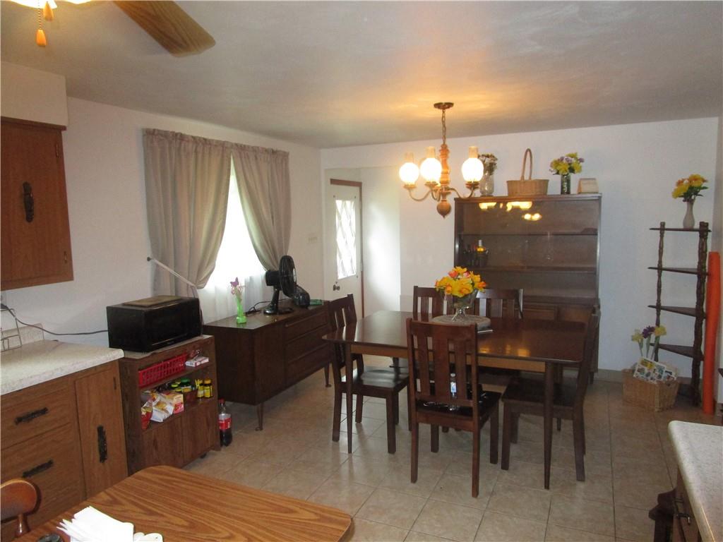 112 State Hill Road Smithton, PA 15479 - Photo 8 of 25 a living room with furniture a dining table and a chandelier