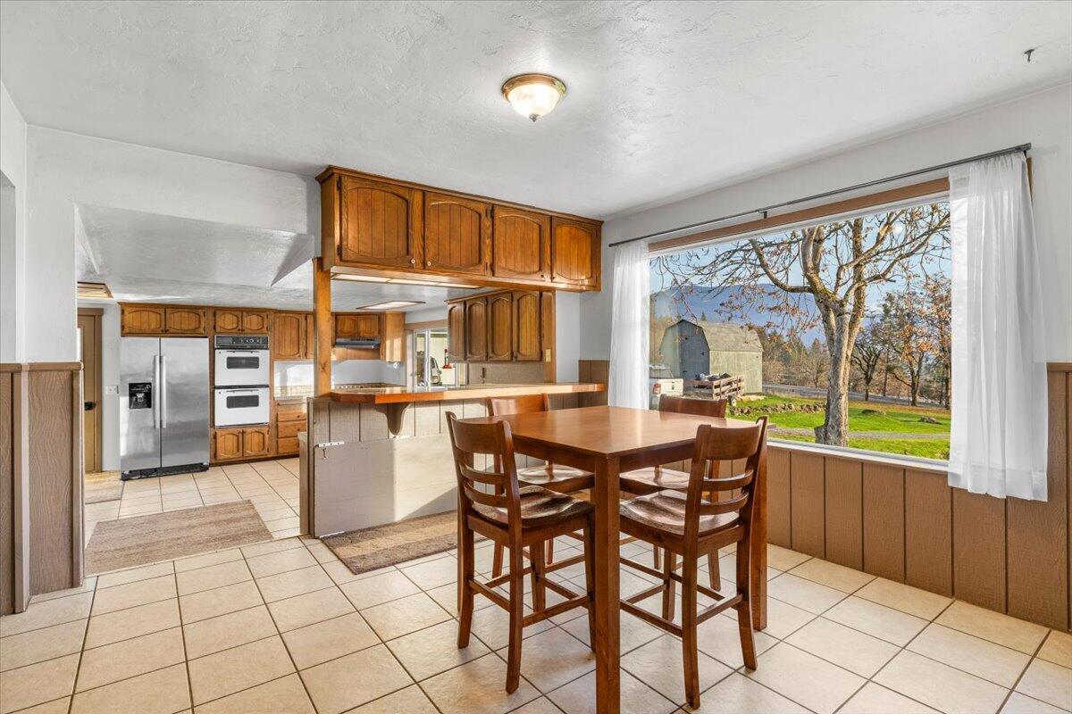 1360 Oxyoke Road Grants Pass, OR 97526 - Photo 12 of 39 a dining room with furniture and large windows