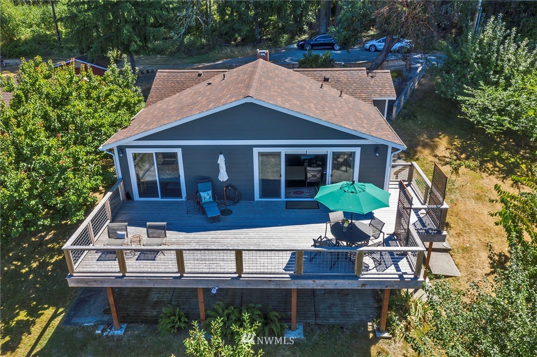 14301 Outer Bay Road Anderson Island, WA 98303 - Photo 1 of 40 a house view with a garden space