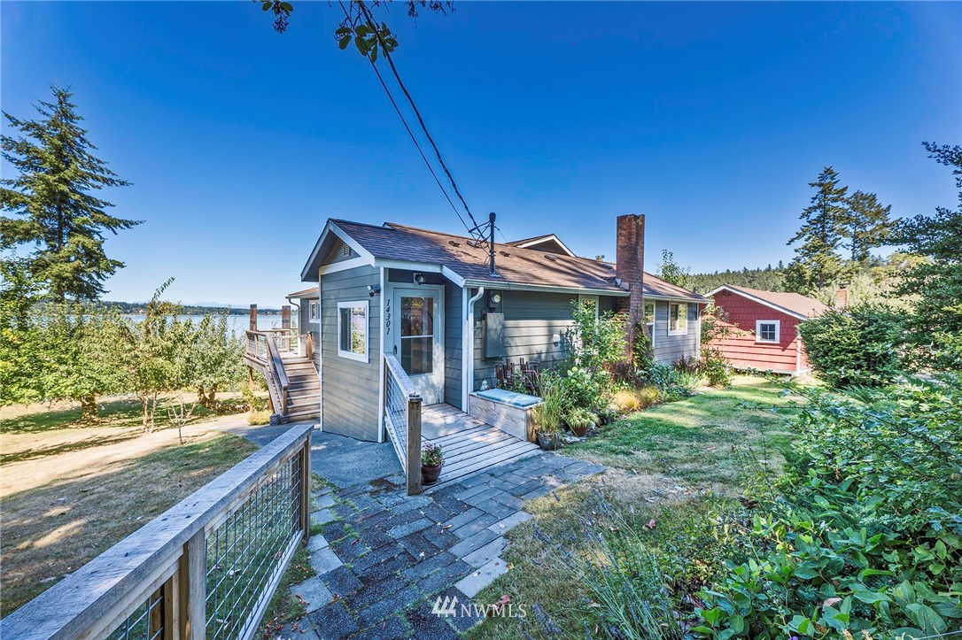 14301 Outer Bay Road Anderson Island, WA 98303 - Photo 2 of 40 a front view of a house with garden