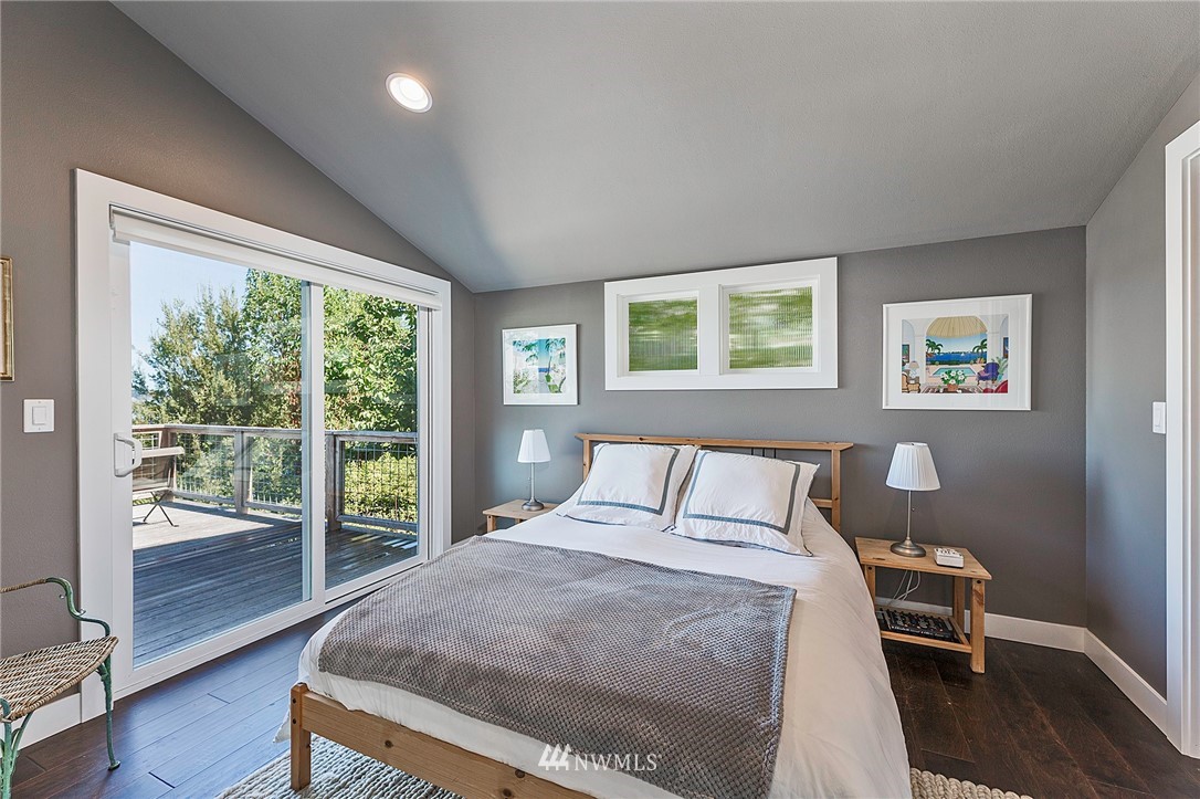 14301 Outer Bay Road Anderson Island, WA 98303 - Photo 13 of 40 a bedroom with a large bed and a large window