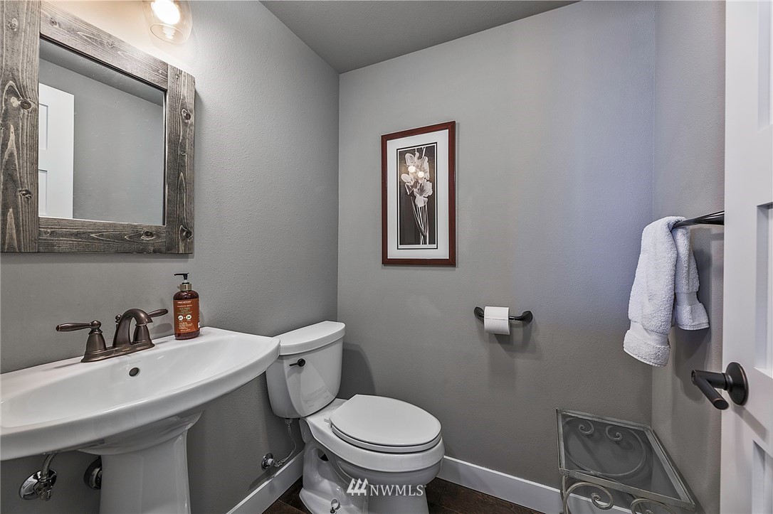 14301 Outer Bay Road Anderson Island, WA 98303 - Photo 19 of 40 a bathroom with a toilet sink and mirror