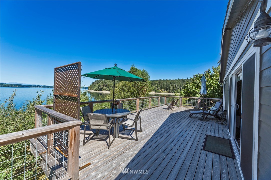 14301 Outer Bay Road Anderson Island, WA 98303 - Photo 23 of 40 a view of balcony with chairs and wooden floor