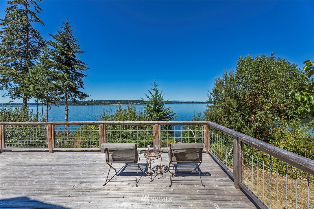 14301 Outer Bay Road Anderson Island, WA 98303 - Photo 25 of 40 a balcony with wooden floor table and chairs