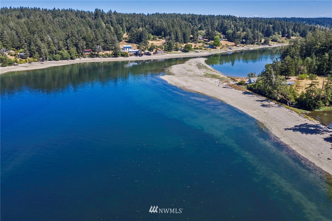 14301 Outer Bay Road Anderson Island, WA 98303 - Photo 4 of 40 a view of a lake with houses in the back