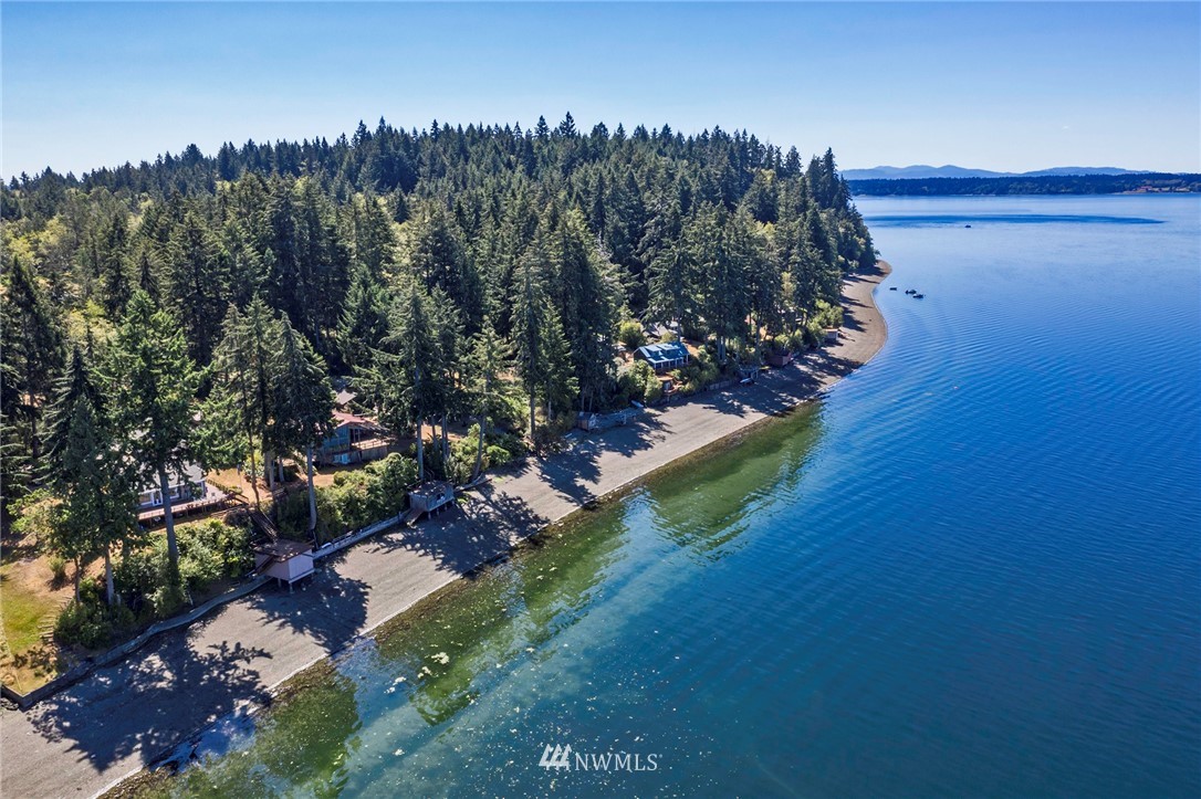 14301 Outer Bay Road Anderson Island, WA 98303 - Photo 39 of 40 a view of a lake with a house in a background