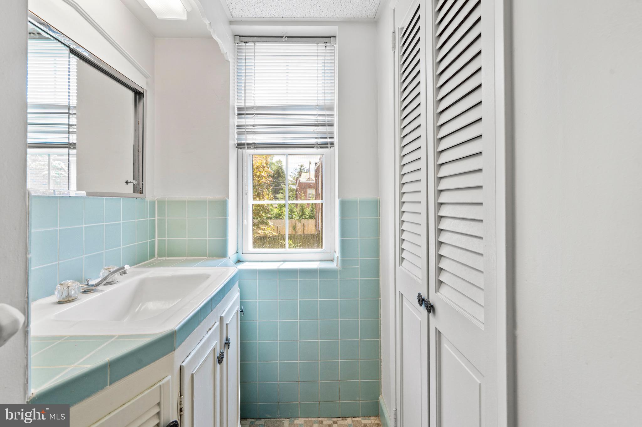 15 Llanfair Road, Unit B Ardmore, PA 19003 - Photo 13 of 25 a bathroom with a sink and a mirror