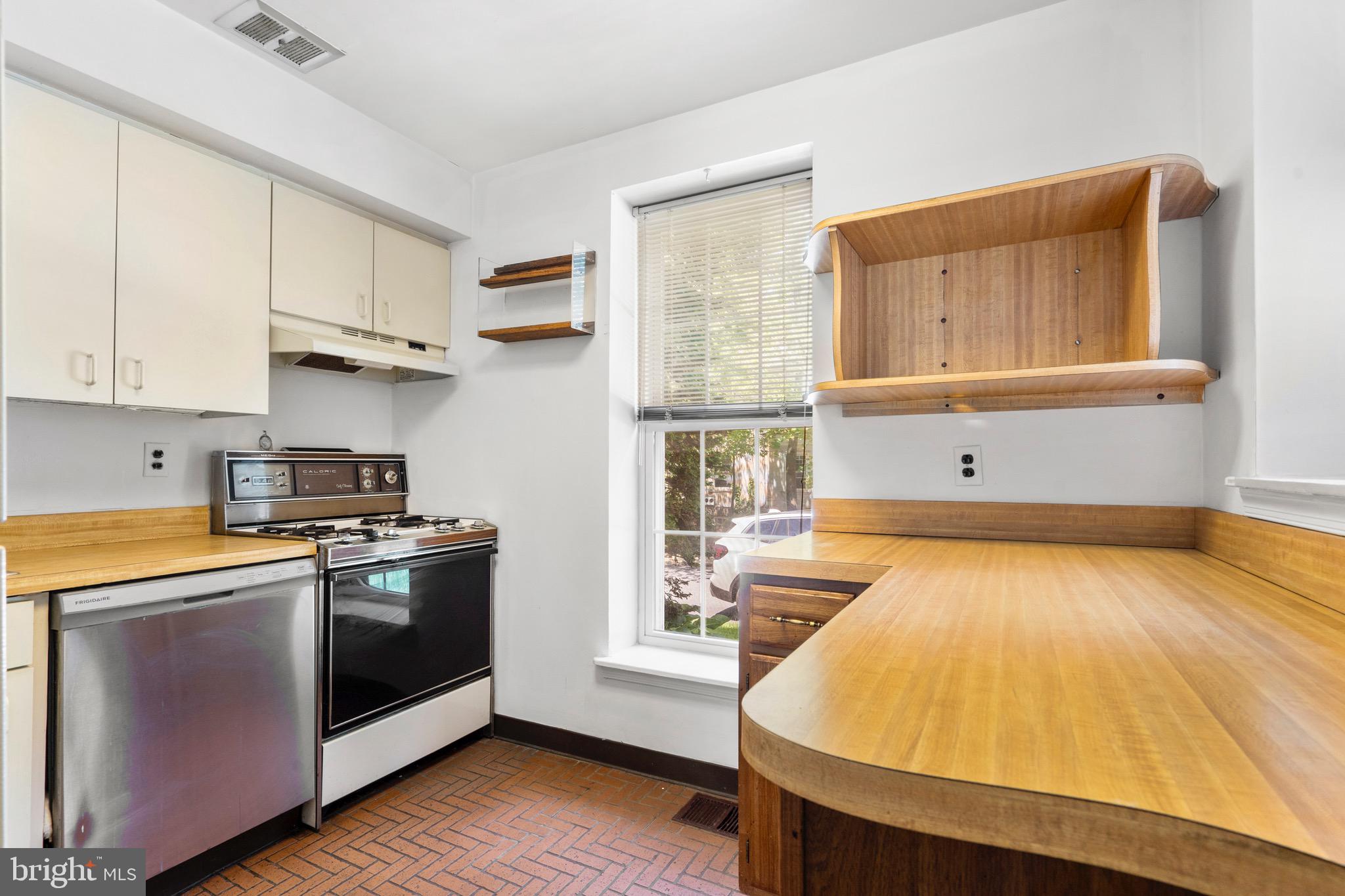 15 Llanfair Road, Unit B Ardmore, PA 19003 - Photo 7 of 25 a kitchen with stainless steel appliances white cabinets and wooden floor