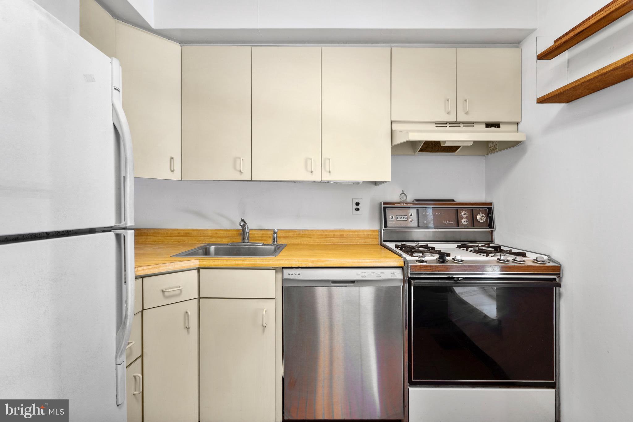 15 Llanfair Road, Unit B Ardmore, PA 19003 - Photo 8 of 25 a kitchen with stainless steel appliances a stove a refrigerator and cabinets