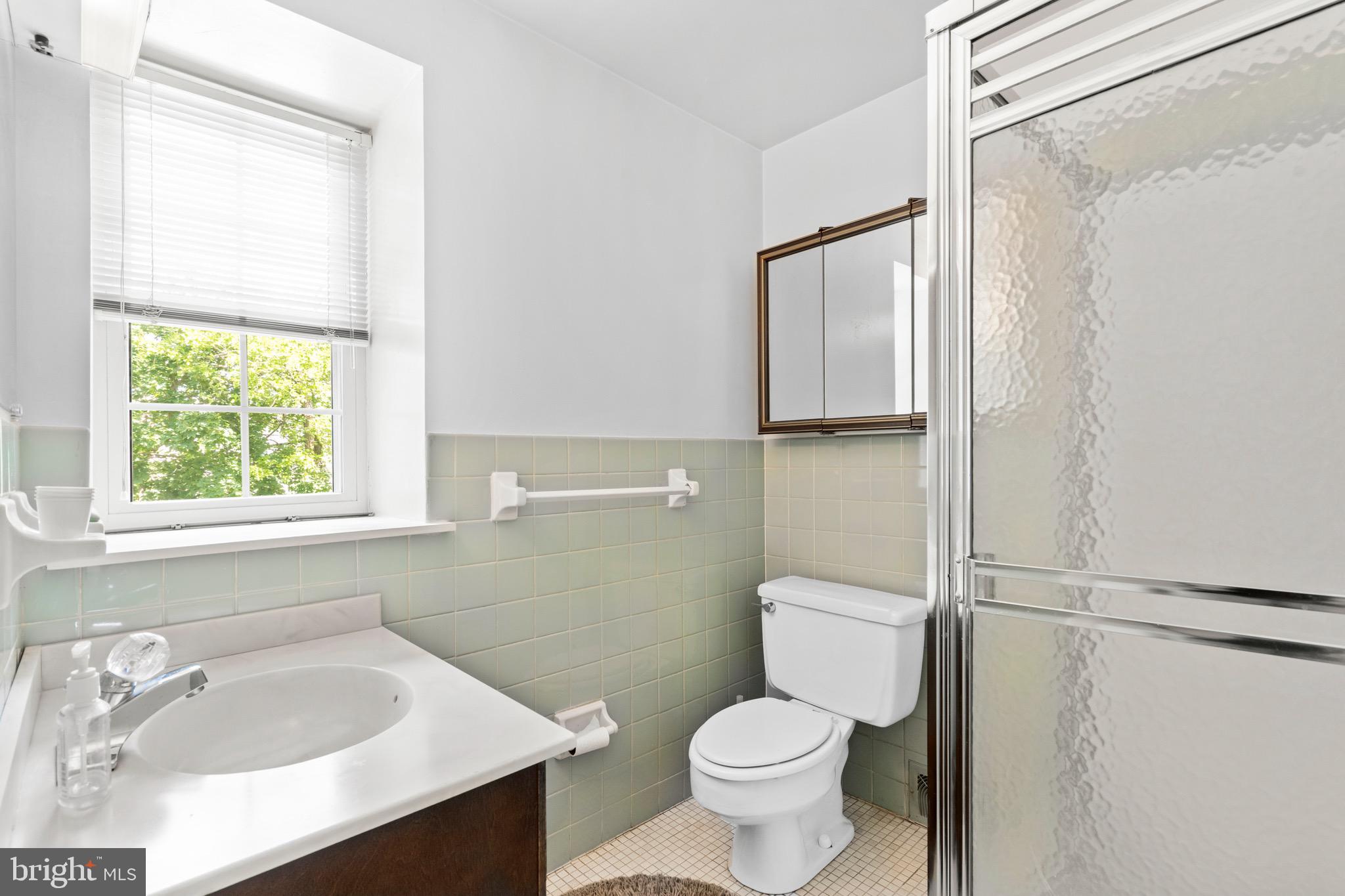 15 Llanfair Road, Unit B Ardmore, PA 19003 - Photo 10 of 25 a bathroom with a sink toilet and shower