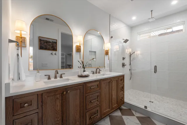 a bathroom with a double vanity sink and a mirror