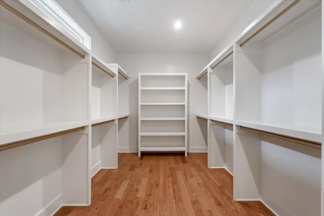 a view of walk in closet with empty racks