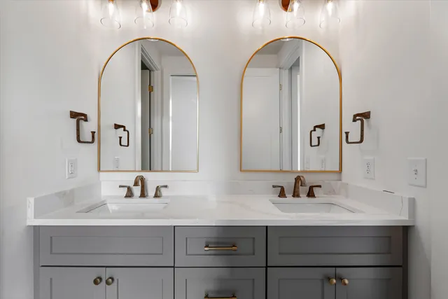 a bathroom with a double vanity sink and a mirror