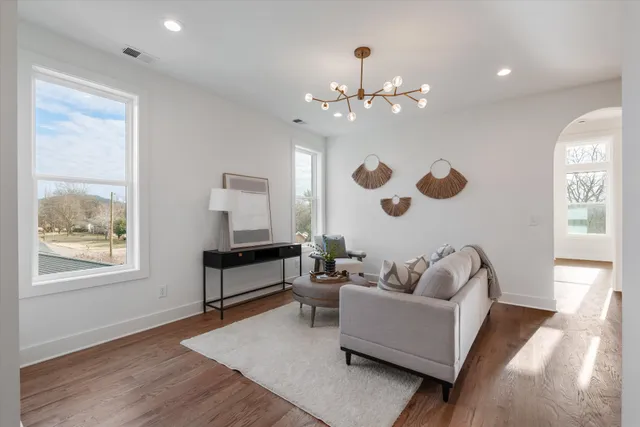 a living room with furniture and a chandelier