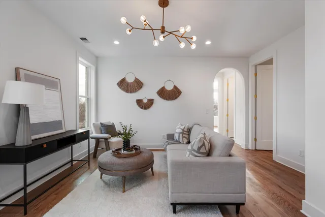 a living room with furniture and a large mirror