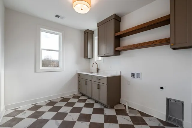 a kitchen with a sink a stove and a window