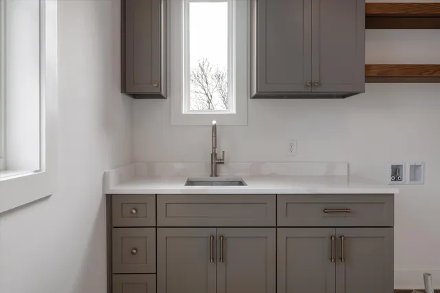 a kitchen with white cabinets and a sink