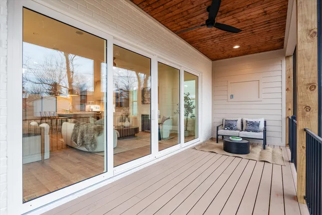 a living room with furniture and a floor to ceiling window