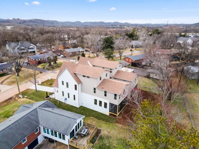 an aerial view of a house with a mountain