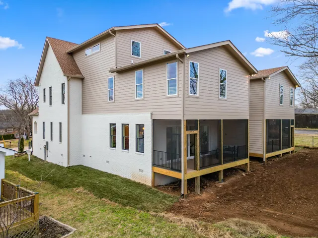 a view of a house with a yard in front of it