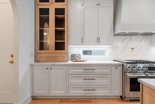 a kitchen with granite countertop white cabinets and stainless steel appliances