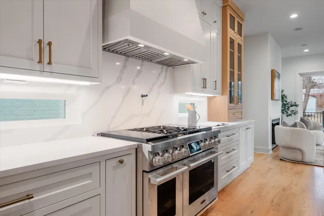 a kitchen with stainless steel appliances granite countertop a stove and a sink