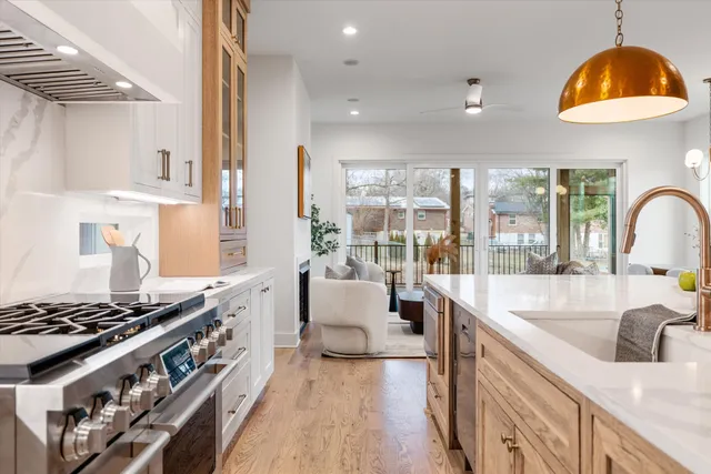 a kitchen with stainless steel appliances granite countertop a sink stove and cabinets