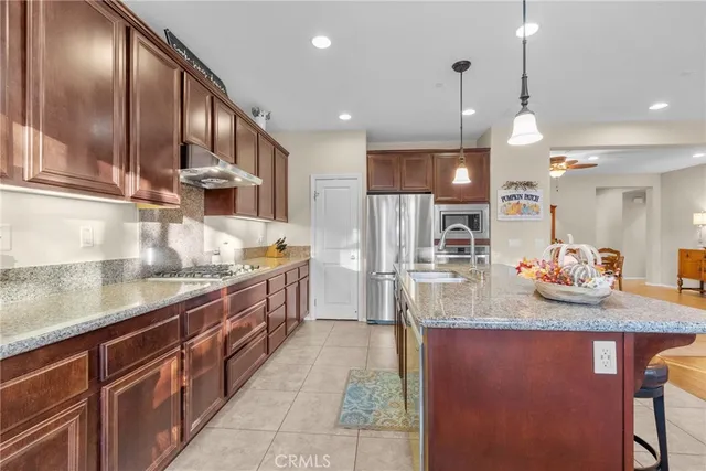 a large kitchen with kitchen island granite countertop wooden cabinets and a granite counter tops