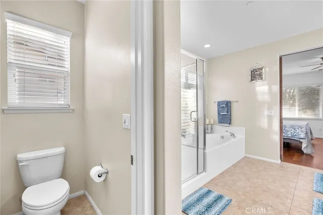 a bathroom with a tub sink shower and mirror