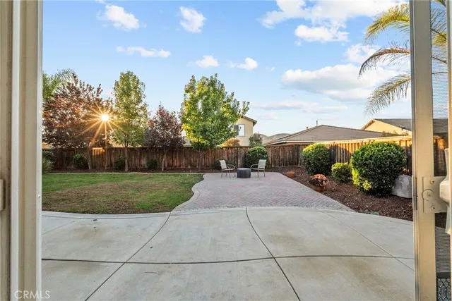 a view of a house with a yard and sitting area