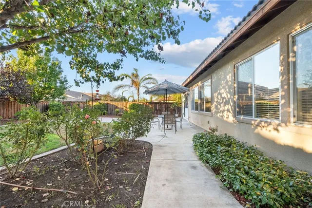 a front view of a house with a yard table and chairs