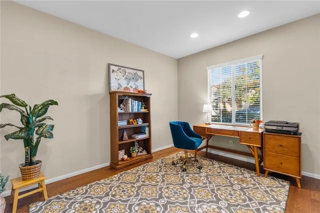 a living room with furniture a rug and a window