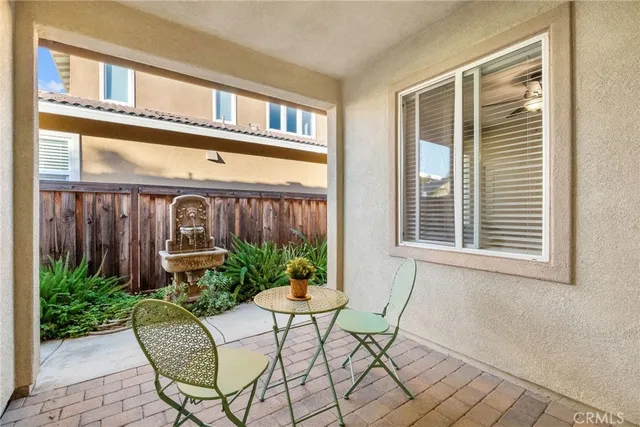 a backyard of a house with table and chairs