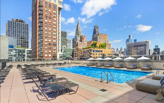 a swimming pool with outdoor seating and yard