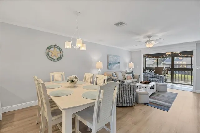 a view of a dining room with furniture large window and wooden floor