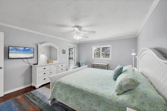 a spacious bedroom with a bed and a chandelier