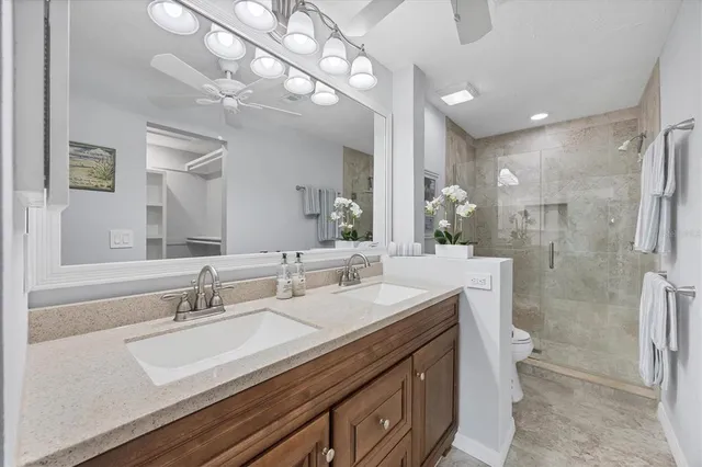 a bathroom with a double vanity sink mirror double and shower