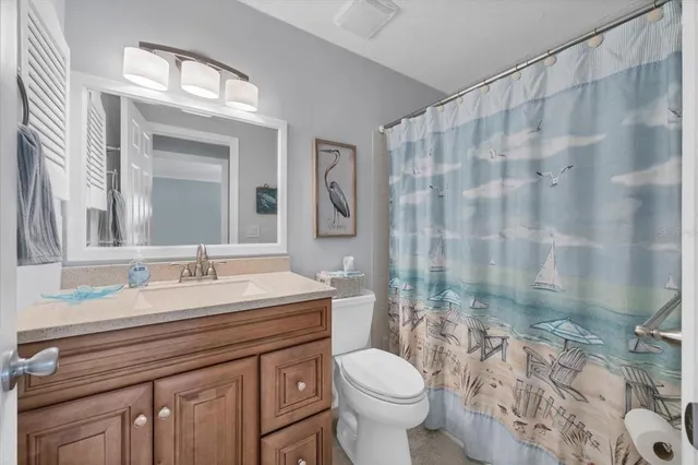 a bathroom with a double vanity sink toilet and shower
