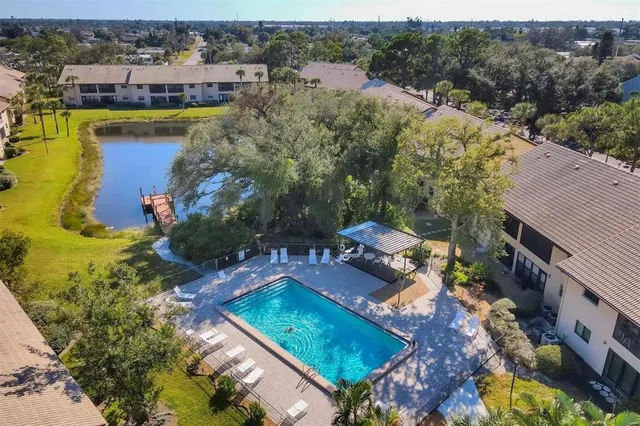 an aerial view of a house with a garden and lake view