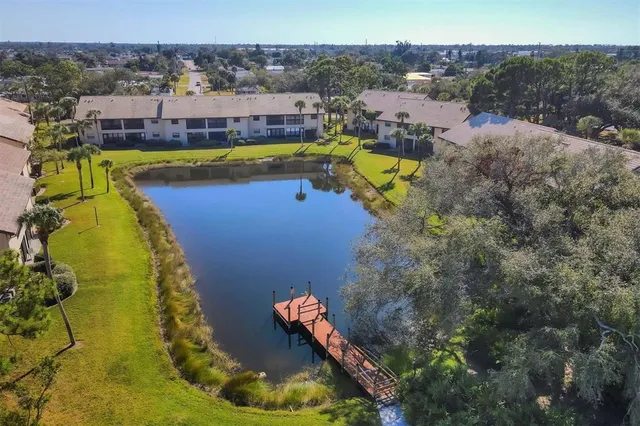 an aerial view of residential houses with outdoor space and swimming pool