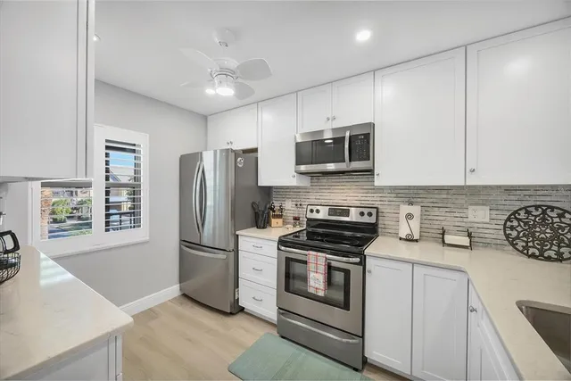 a kitchen with stainless steel appliances a stove microwave and refrigerator